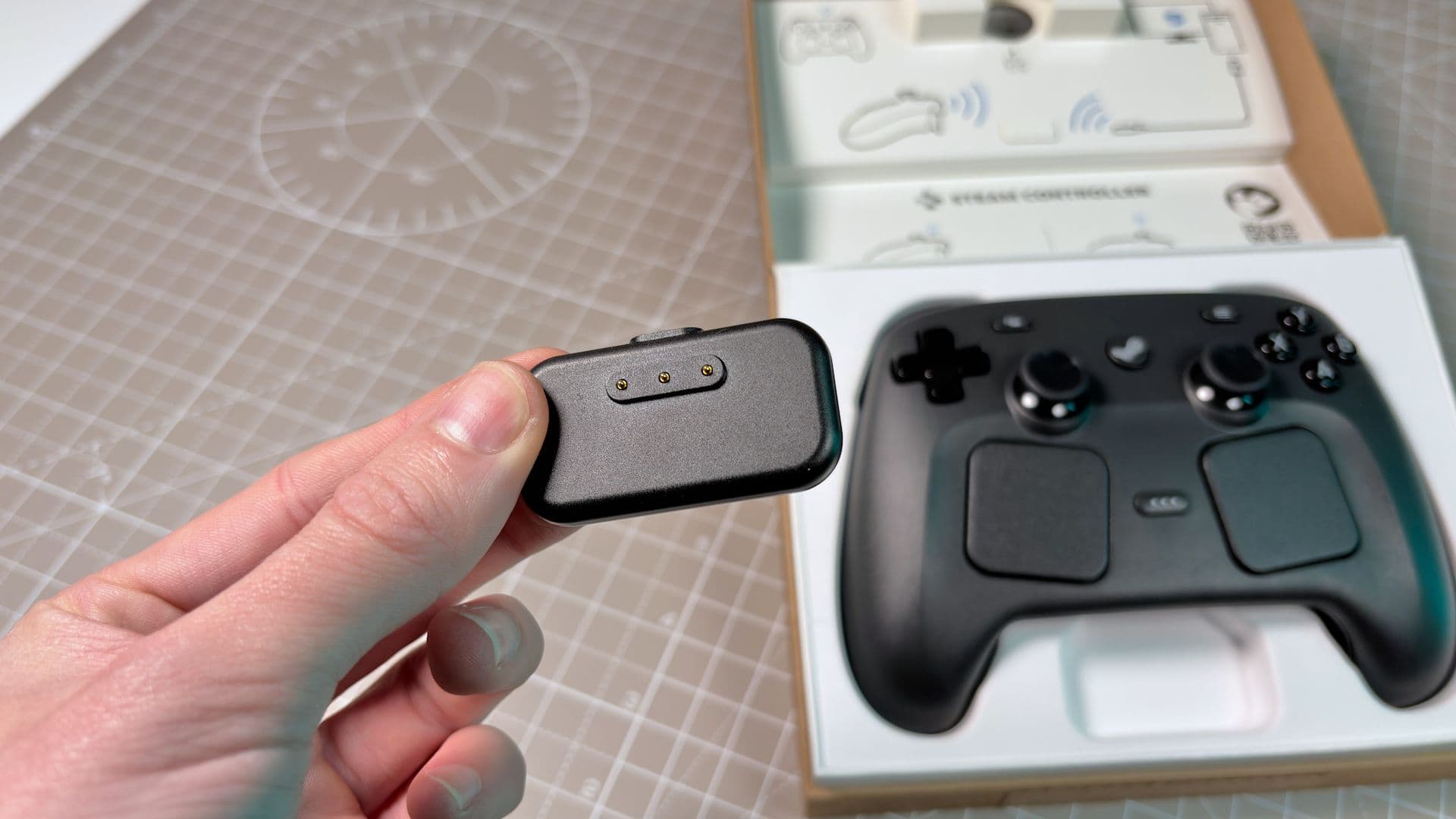 You need to know the Steam Controller's charging puck is always live, so if you accidentally touch it with something conductive, you're in for a shock